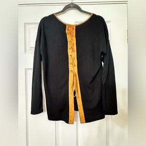 Cute black shirt with suede like leather details!